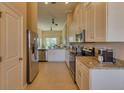 Modern kitchen with stainless steel appliances and granite countertops at 13816 Messina Loop # 203, Bradenton, FL 34211
