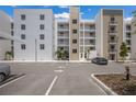Modern building exterior with parking and landscaped areas at 1703 N Tamiami Trl # 210, Sarasota, FL 34234