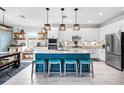 Bright kitchen with a large center island, granite countertops, and stainless steel appliances at 17335 Polo Trl, Bradenton, FL 34211