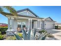 Gray house with two-car garage and welcoming front porch at 1825 Twin Rivers Trl, Parrish, FL 34219