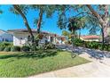 Attractive one-story home nestled amongst mature trees and landscaping at 197 Grand Oak Cir, Venice, FL 34292