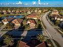 House in a Florida neighborhood with similar homes and a lake nearby at 20680 Vita Ct, Venice, FL 34293