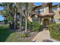 Ground level view of condo building with lush landscaping at 2251 Jessie Harbor Dr # 2101, Osprey, FL 34229
