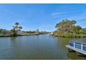 Peaceful waterfront view with boats and lush vegetation at 2251 Jessie Harbor Dr # 2101, Osprey, FL 34229