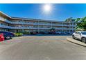 Exterior view of a multi-story condo complex with a well-maintained parking lot at 2435 Sumatran Way # 35, Clearwater, FL 33763