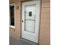 White front door with glass panels and a storm door at 2435 Sumatran Way # 35, Clearwater, FL 33763