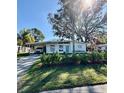 Mid-century modern home with lush landscaping and a paved driveway at 2946 Bay St, Sarasota, FL 34237