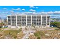 Luxury beachfront condo with large windows, balconies, and a private boardwalk to the beach and lush landscaping at 420 Beach Rd # 203, Sarasota, FL 34242