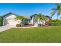House exterior showcasing a well-manicured lawn at 527 Rotonda Cir, Rotonda West, FL 33947