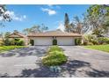 Three-unit building showcasing Spanish-style architecture, and two-car garages at 5575 Golf Pointe Dr, Sarasota, FL 34243