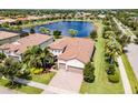 Two-story house with a lake view and nicely landscaped yard at 5610 Rain Lily Ct, Sarasota, FL 34238
