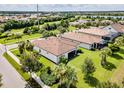 Aerial view of a house with a large backyard and lake in background at 5610 Rain Lily Ct, Sarasota, FL 34238