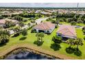 Aerial view of two houses with a shared backyard and lake view at 5610 Rain Lily Ct, Sarasota, FL 34238