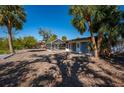 Backyard with a screened-in patio, palm trees, and a dock at 6536 Sabal Dr, Sarasota, FL 34242