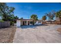 One-story home with a driveway, carport, and some landscaping at 6536 Sabal Dr, Sarasota, FL 34242