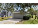 House exterior showcasing a gray garage and landscaping at 10215 36Th E Ct, Parrish, FL 34219