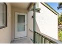 Exterior view of condo building entrance with private balcony at 1526 Pelican Point Dr # 245, Sarasota, FL 34231