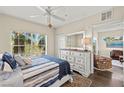 Spacious bedroom with a comfortable bed, dresser, and plenty of natural light at 2060 Willow Hammock Cir # 304, Punta Gorda, FL 33983