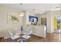 Charming dining area with glass table and chairs, and an open kitchen concept at 2060 Willow Hammock Cir # 304, Punta Gorda, FL 33983