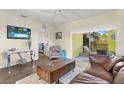 Bright living room with comfortable seating, hardwood floors, and access to a balcony at 2060 Willow Hammock Cir # 304, Punta Gorda, FL 33983