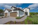 Two-car garage with paver driveway and nicely landscaped front yard at 26903 Pavin Dr, Englewood, FL 34223