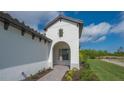 Front entry with arched detail and paver walkway at 26903 Pavin Dr, Englewood, FL 34223