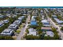 Aerial view of coastal neighborhood, highlighting a newly built three-unit property at 303 65Th St # B, Holmes Beach, FL 34217
