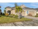 A charming home boasts a two-car garage, pristine landscaping, and a beautifully designed paver driveway at 3115 Trustee Ave, Sarasota, FL 34243