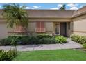 House exterior showcasing a walkway, landscaping, and light brown siding at 3520 57Th Avenue W Cir # 10, Bradenton, FL 34210