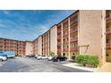 Exterior view of a multi-story condominium building with parking at 4067 Lake Bayshore Dr # 302, Bradenton, FL 34205