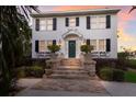 Two story home with a green door and brick steps at 4110 Riverview Blvd, Bradenton, FL 34209