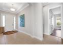 Spacious entryway with tile floors, neutral walls, and access to other rooms at 5397 Bartolomeo St, Sarasota, FL 34238