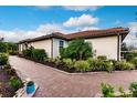 A home with a brick paver walkway and nicely landscaped yard at 6226 Plateau Ct, Bradenton, FL 34203