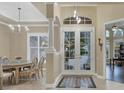 Bright dining room with a table for six and access to the foyer at 7041 Beechmont Ter, Lakewood Ranch, FL 34202