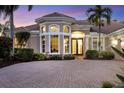 Inviting home exterior featuring a circular driveway and manicured landscaping at 7041 Beechmont Ter, Lakewood Ranch, FL 34202