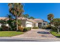 Well-maintained house with attractive landscaping and a paver driveway at 7156 Rue De Palisades # 3, Sarasota, FL 34238