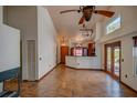 Open living room showcases tile floors, high ceilings and flows into the adjacent kitchen with breakfast bar at 7806 Ontario Street Cir # 7806, Sarasota, FL 34243