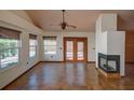 Open-concept living room featuring tile floors, a fireplace, and French doors to the outdoor space at 7806 Ontario Street Cir # 7806, Sarasota, FL 34243