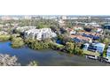 Aerial view of waterfront condo community near downtown, showcasing lush landscaping and waterways at 850 S Tamiami Trl # 402, Sarasota, FL 34236