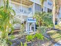 Exterior view of condo building with landscaping and signage indicating Building 4 at 850 S Tamiami Trl # 402, Sarasota, FL 34236