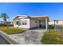 Side view of a manufactured home with covered patio at 1111 49Th Avenue W Dr, Bradenton, FL 34207