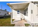 Front entrance of the manufactured home with steps and handrail at 1111 49Th Avenue W Dr, Bradenton, FL 34207