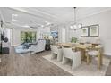 Open-concept dining area complemented by wood tile floors and ample natural light at 13021 Indigo Way, Bradenton, FL 34211