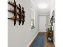 Bright entryway with tile flooring, a long runner, and decorative shelving at 153 Soliera St, Nokomis, FL 34275