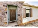 Inviting front exterior with stone accents and a covered entryway at 16351 Coconut Palm Dr, Port Charlotte, FL 33953