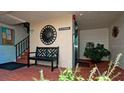 Building entrance with elevator, stairs, and seating at 3705 E Bay Dr # 212, Holmes Beach, FL 34217