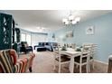 Open concept dining area with a table and chairs, adjacent to a living area at 3705 E Bay Dr # 212, Holmes Beach, FL 34217