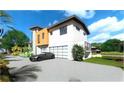 Modern home with attached garage and landscaping at 5174 Sandy Cove Ave, Sarasota, FL 34242