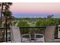 Balcony with seating overlooking a golf course and city view at sunset at 545 Sanctuary Dr # B406, Longboat Key, FL 34228