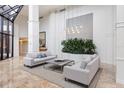 Elegant lobby with high ceilings, natural light, plush seating, and modern decor at 545 Sanctuary Dr # B406, Longboat Key, FL 34228